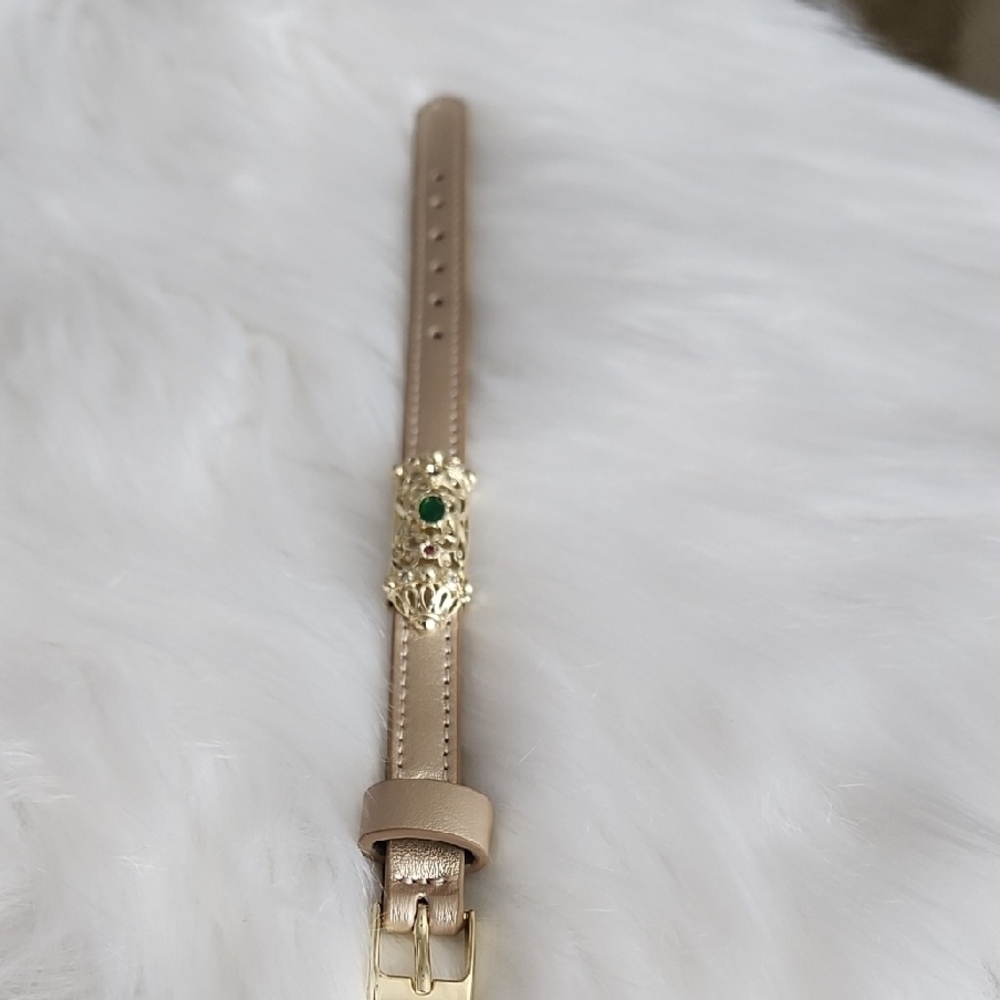 Elegant Tan Bracelet with Gold and Green Accents